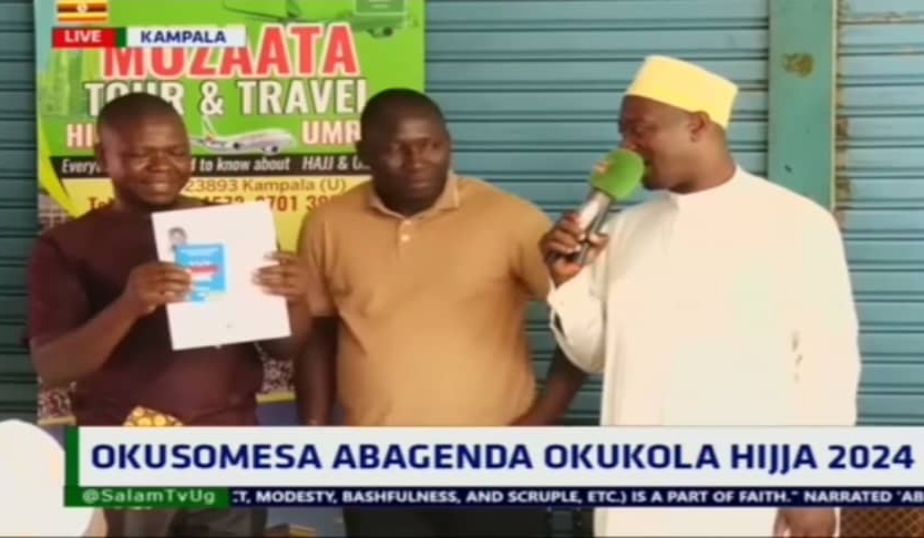 This year's winner  of Omumanyi wa Salam receives travel documents for Hajj pilgrimage