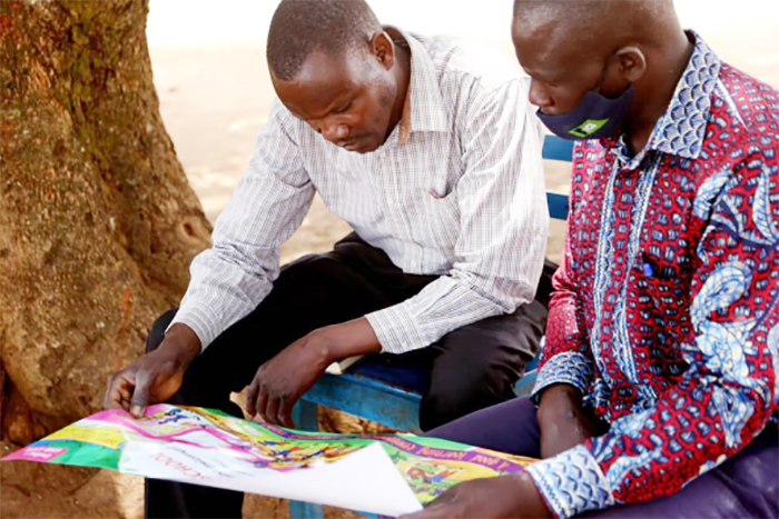 School teachers going through the Good School Toolkit in class with pupils | Courtesy-FIRD-Uganda
