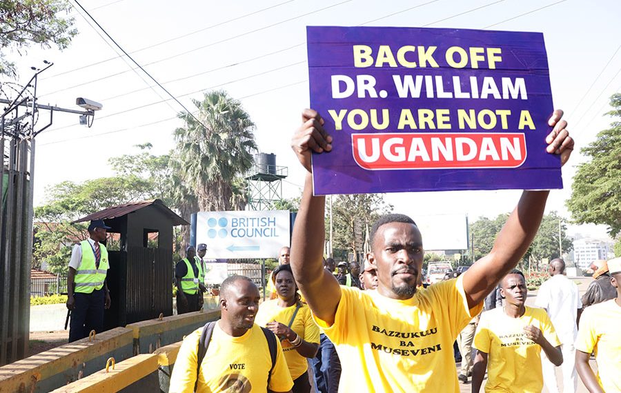 The activists carry placards at the British High Commission.(PHOTO BY Kenneth Kazibwe).