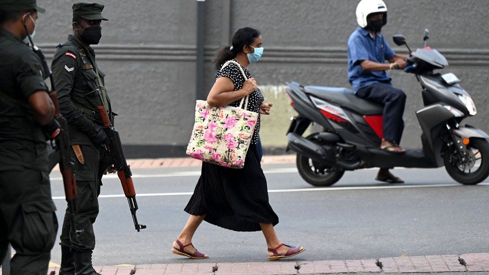 Sri Lanka cabinet resigns as crisis protesters defy curfew